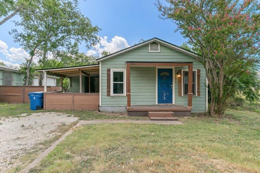 Bungalow-style home with a front lawn and a porch Bungalow-style home with a front lawn and a porch