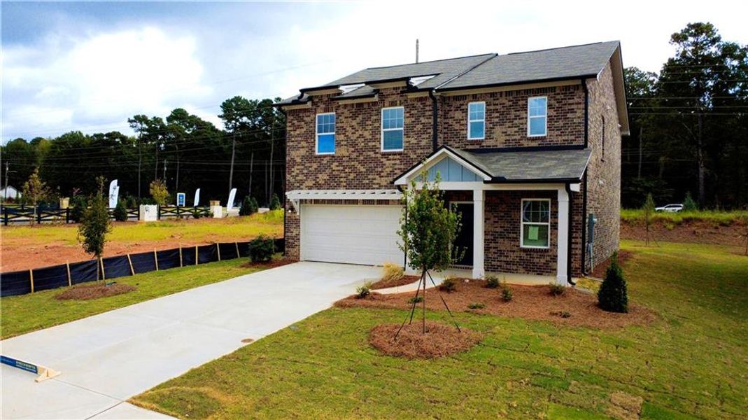 Front exterior of a new home in Kendall Grove, McDonough, GA, highlighting curb appeal (Image 1). Front exterior of a new home in Kendall Grove, McDonough, GA, highlighting curb appeal (Image 1).