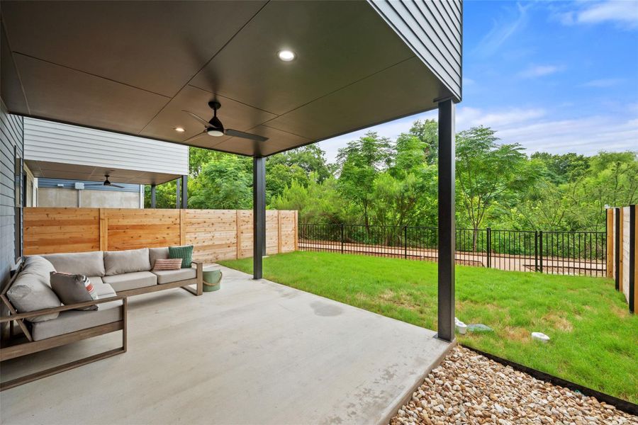 A spacious covered patio invites relaxation with a lush green backdrop. A spacious covered patio invites relaxation with a lush green backdrop.