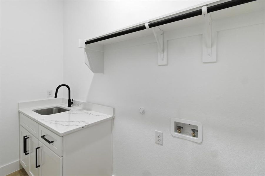 Laundry room with gas dryer hookup, hookup for a washing machine, and cabinet space