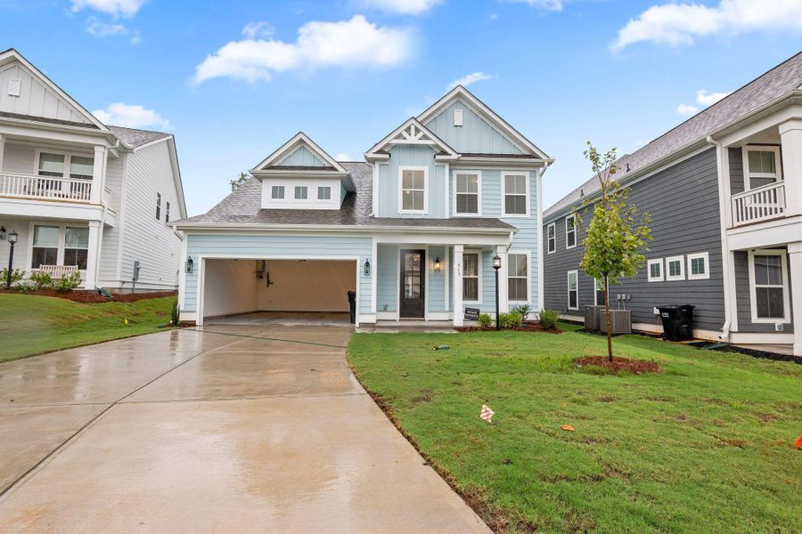 Front exterior of a new home in Tidewater at Lakes of Cane Bay, Summerville, SC, highlighting curb appeal (Image 1). Front exterior of a new home in Tidewater at Lakes of Cane Bay, Summerville, SC, highlighting curb appeal (Image 1).
