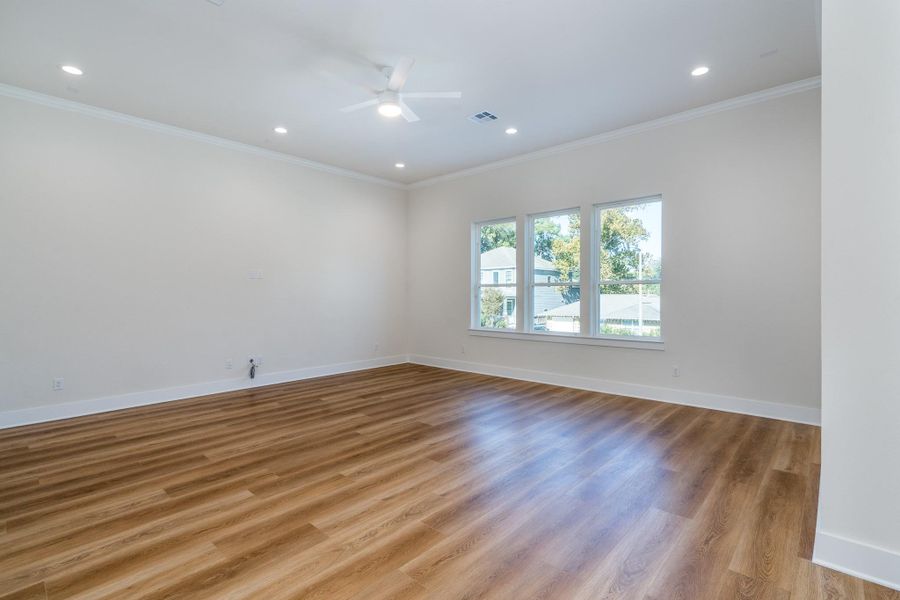 This expansive room is located on the primary floor and can be utilized as a second primary bedroom or a game room. This expansive room is located on the primary floor and can be utilized as a second primary bedroom or a game room.