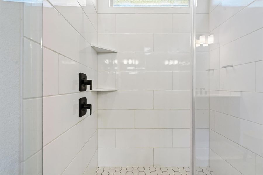Bathroom featuring a shower stall Bathroom featuring a shower stall