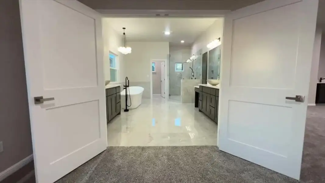 Bathroom with vanity, walk in shower, and a freestanding tub