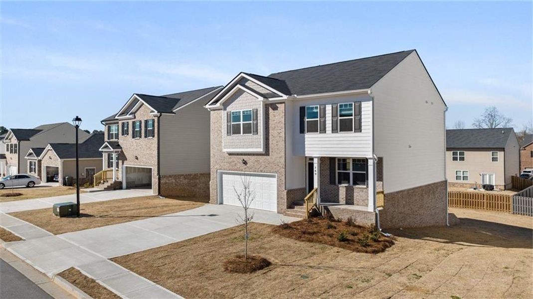 Front exterior of a new home in The Reserve at Calcutta, Stockbridge, GA, highlighting curb appeal (Image 21). Front exterior of a new home in The Reserve at Calcutta, Stockbridge, GA, highlighting curb appeal (Image 21).