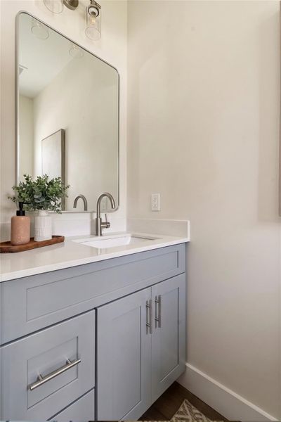 A well-appointed bathroom features a sleek vanity with ample storage and contemporary fixtures.