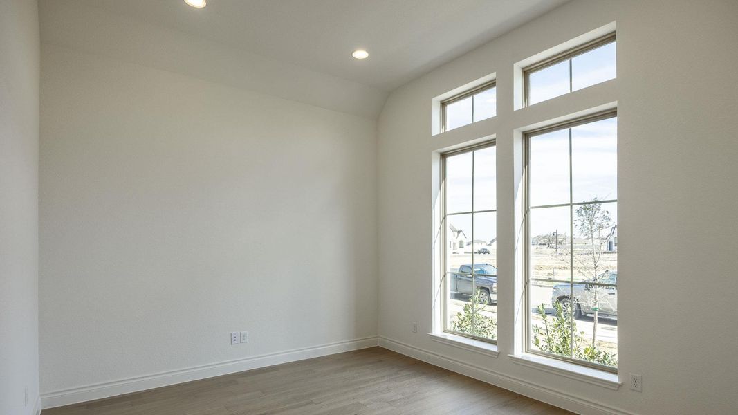 Unfurnished room with recessed lighting, wood finished floors, and baseboards Unfurnished room with recessed lighting, wood finished floors, and baseboards