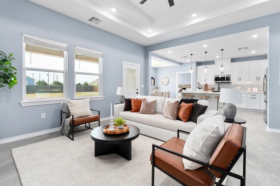 Living area featuring recessed lighting, ceiling fan, and a raised ceiling Living area featuring recessed lighting, ceiling fan, and a raised ceiling