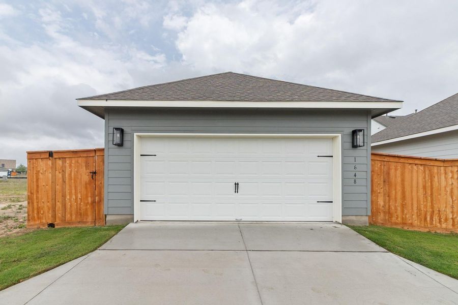 Garage featuring concrete driveway