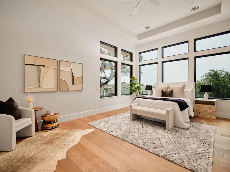 An airy bedroom with tall windows, boasting abundant natural illumination and a tranquil ambiance. An airy bedroom with tall windows, boasting abundant natural illumination and a tranquil ambiance.
