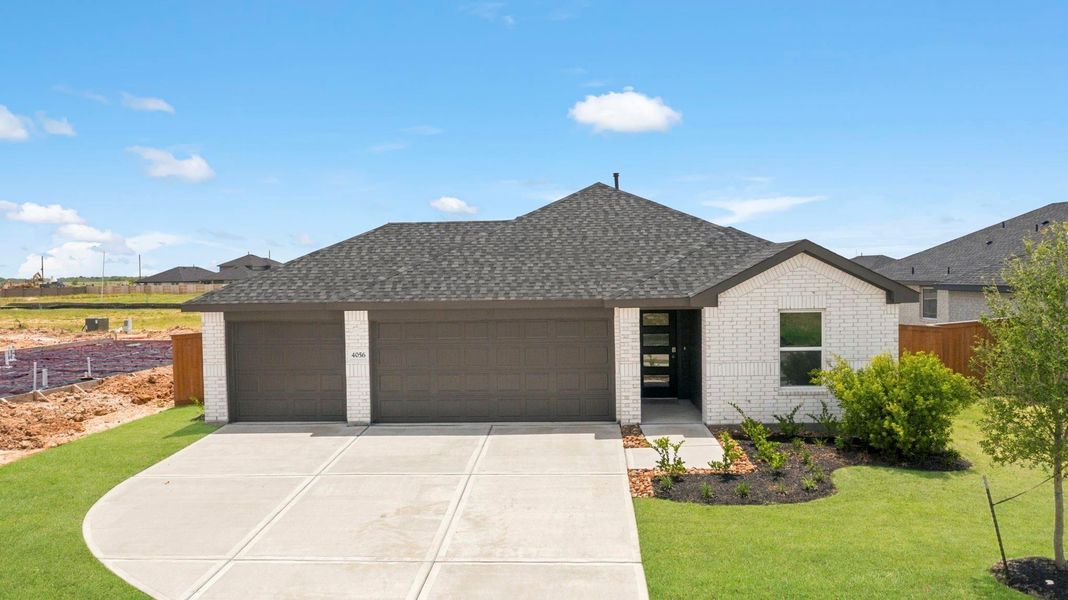 Front exterior of a new home in Sunterra Lakes, Brookshire, TX, highlighting curb appeal (Image 1). Front exterior of a new home in Sunterra Lakes, Brookshire, TX, highlighting curb appeal (Image 1).