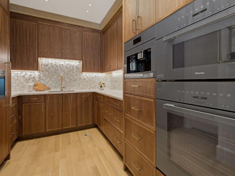 Custom cabinetry with integrated appliances and under-cabinet lighting
