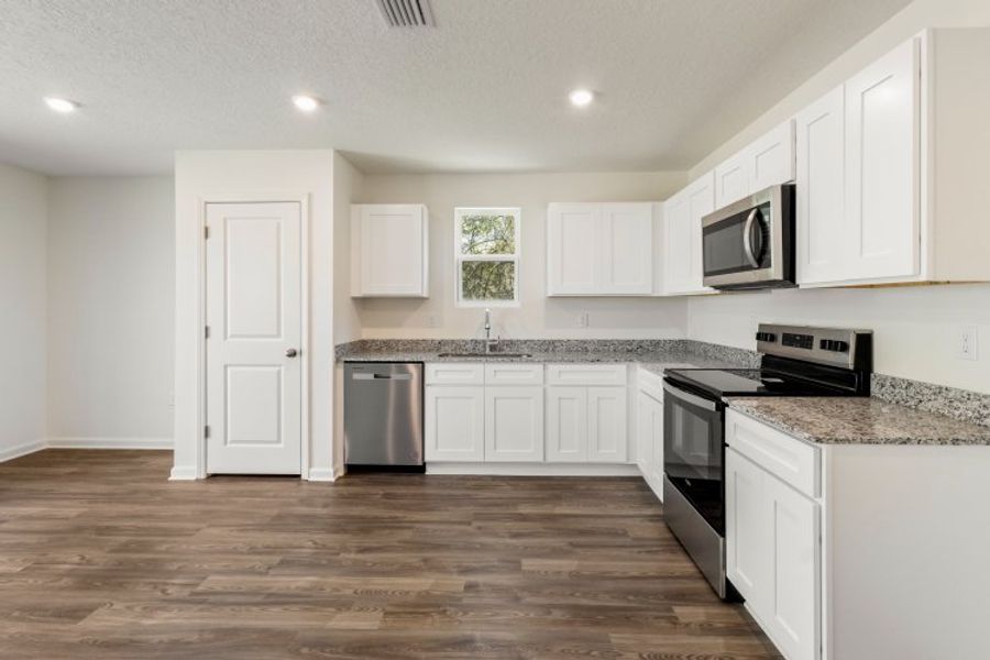 A kitchen with white cabinets. A kitchen with white cabinets.