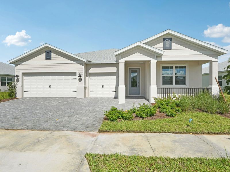 Front exterior of a new home in Crescent Lakes - Signature Series, Punta Gorda, FL, highlighting curb appeal (Image 1).