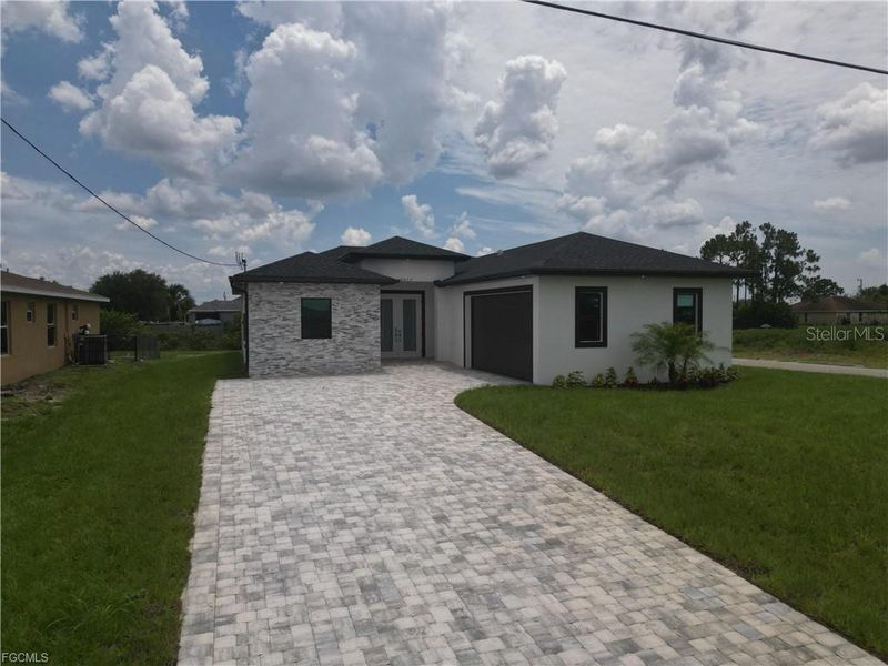 Front exterior of a new home in , Lehigh Acres, FL, highlighting curb appeal (Image 14).