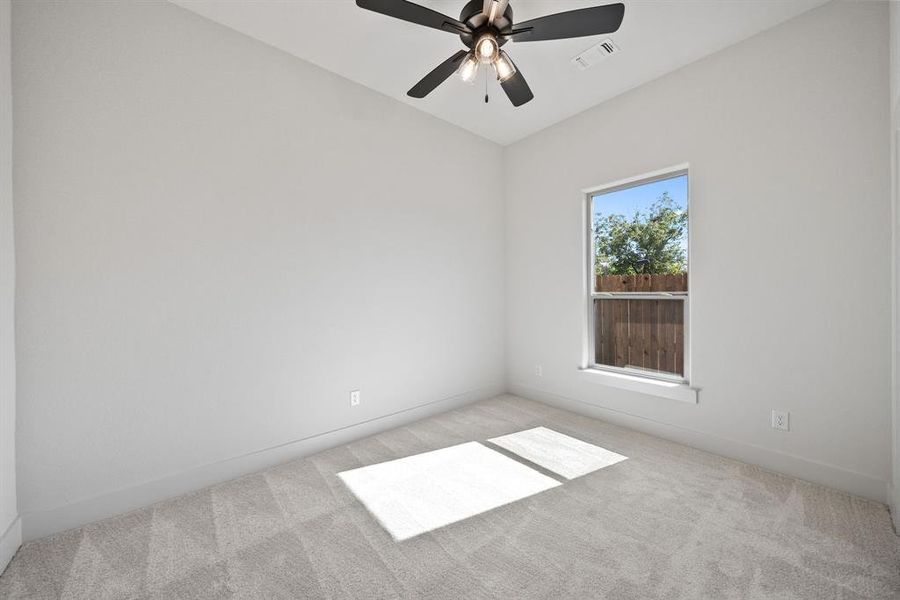 Unfurnished room with light carpet and ceiling fan