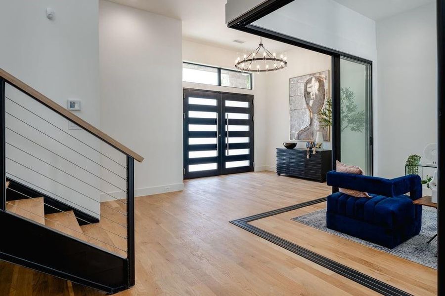 Foyer with a notable chandelier, light hardwood / wood-style flooring, and french doors