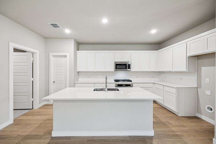 Kitchen in the Oscar home plan by Trophy Signature Homes – REPRESENTATIVE PHOTO Kitchen in the Oscar home plan by Trophy Signature Homes – REPRESENTATIVE PHOTO