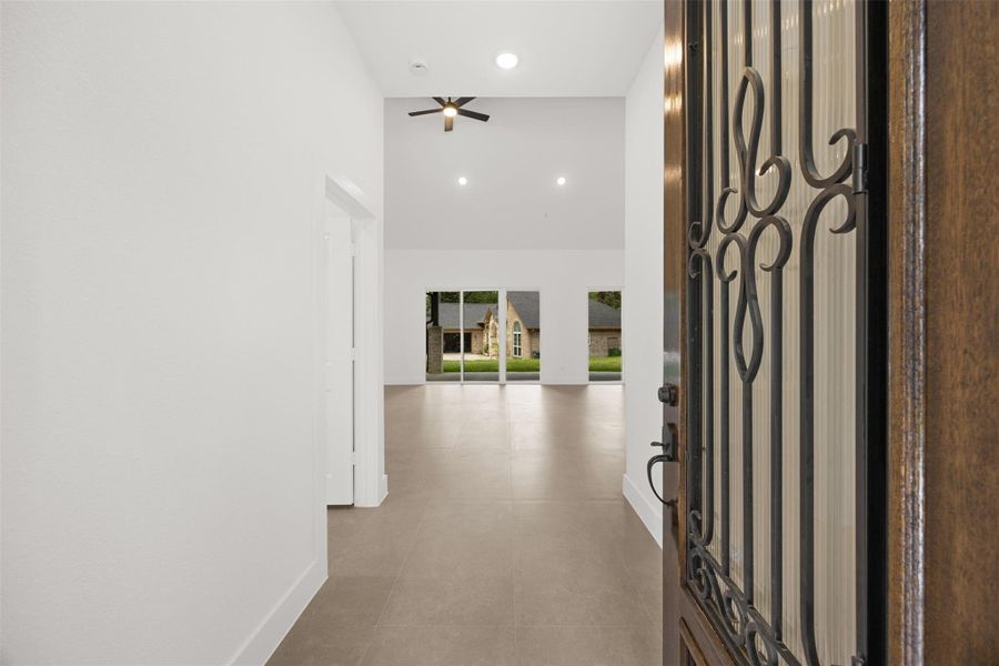 Grand entry welcomes you with a solid wood front door and views straight through to the open-concept living space.