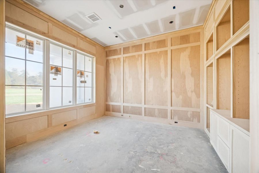Private home office with large windows and natural light.