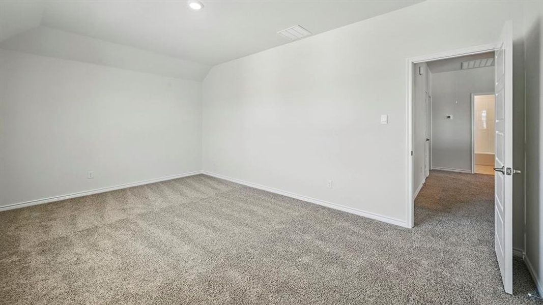 Spare room featuring carpet, vaulted ceiling, and recessed lighting Spare room featuring carpet, vaulted ceiling, and recessed lighting