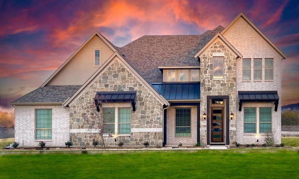French provincial home featuring a standing seam roof, a front yard, roof with shingles, and stone siding