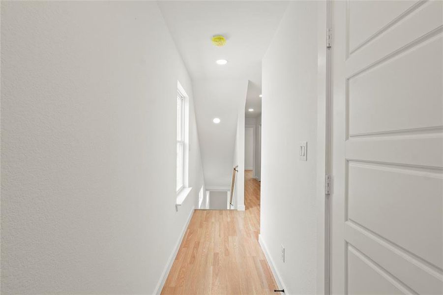 Hall with light hardwood / wood-style flooring