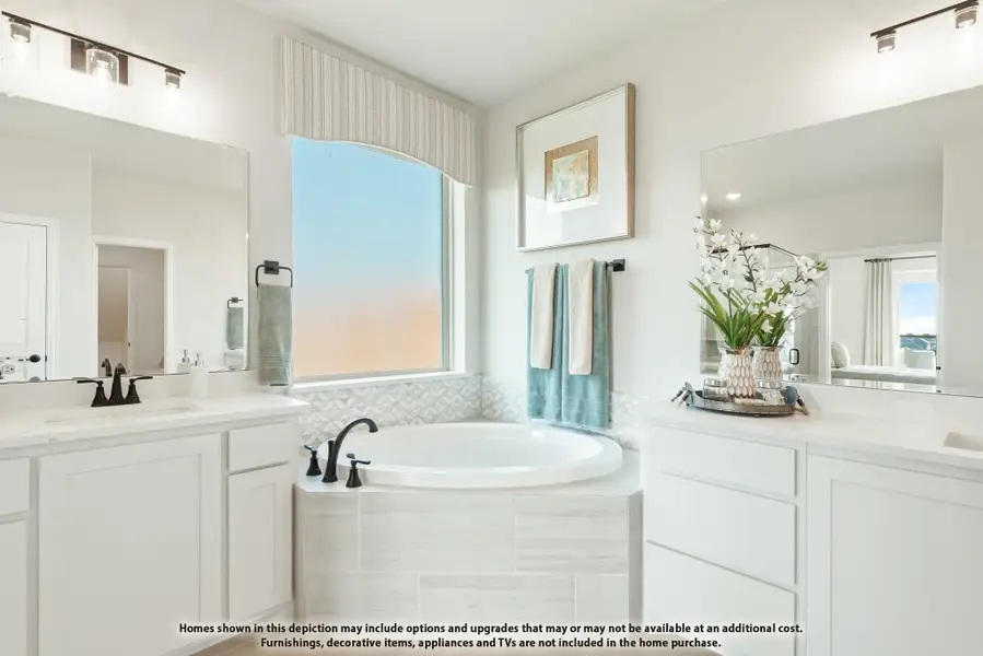 Master bathroom with soaking tub, dual vanities, white cabinets, and large window Master bathroom with soaking tub, dual vanities, white cabinets, and large window