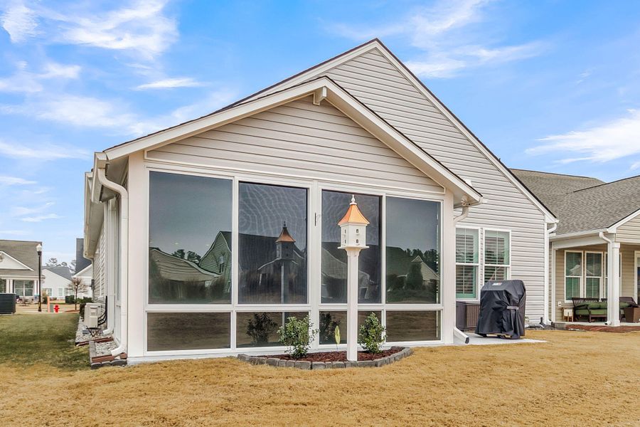 Exterior details and patio area of a home in K. Hovnanian's® Four Seasons at Lakes of Cane Bay, Summerville (Image 23).