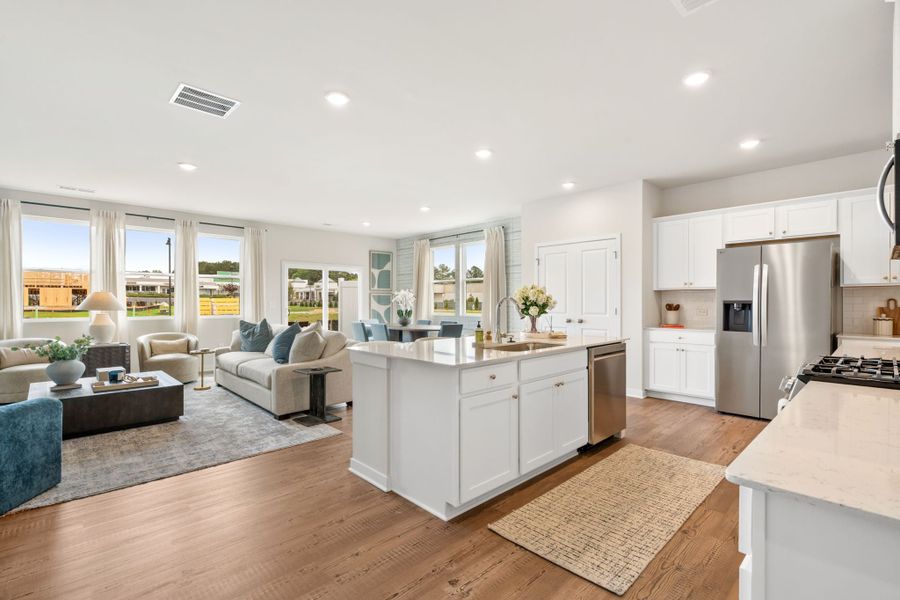 A large kitchen with white cabinets. A large kitchen with white cabinets.