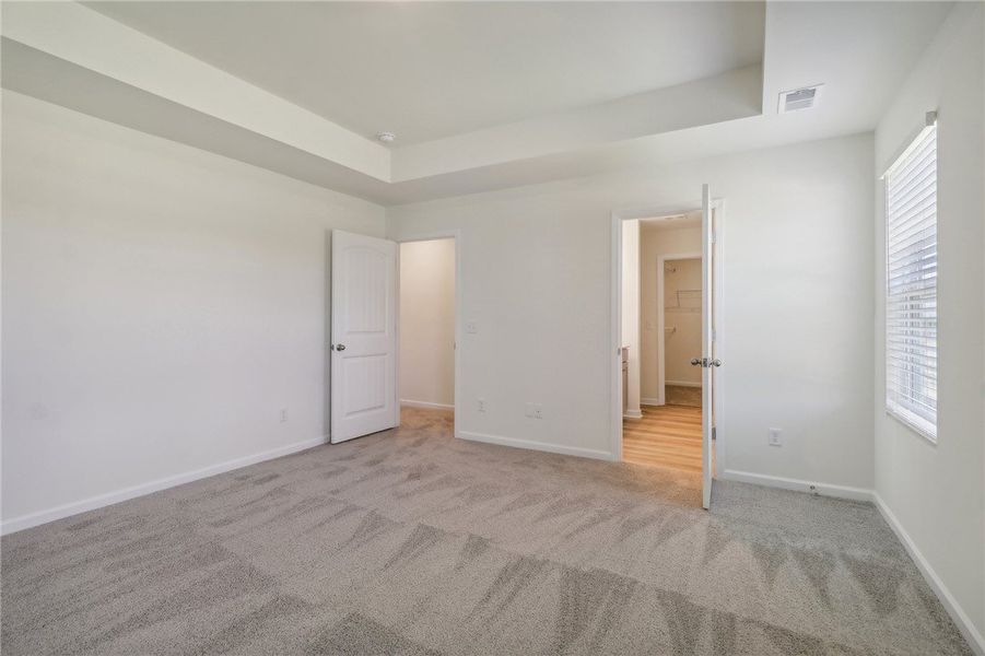 This spacious bedroom offers comfortable carpeting This spacious bedroom offers comfortable carpeting