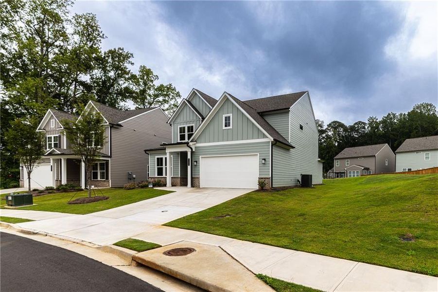 Front exterior of a new home in , Canton, GA, highlighting curb appeal (Image 23).