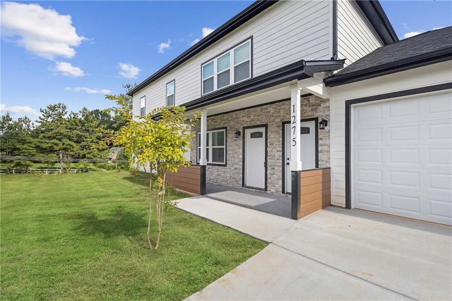 Front exterior of a new home in , Sugar Hill, GA, highlighting curb appeal (Image 1).