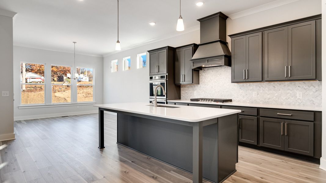 Modern kitchen with nearby dining area with abundance of natural light