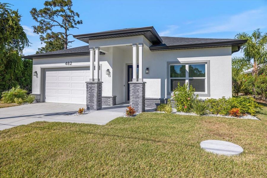 Front exterior of a new home in , Rotonda West, FL, highlighting curb appeal (Image 24).