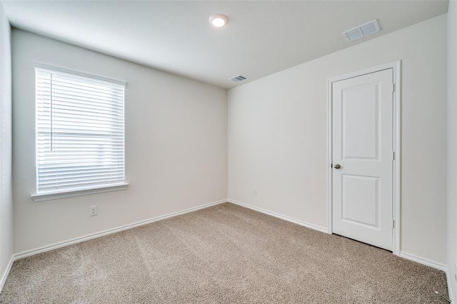 Empty room with light colored carpet