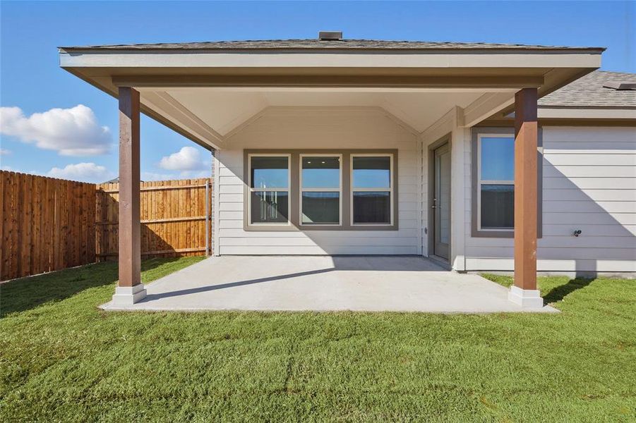 Back of property featuring a patio and a shingled roof