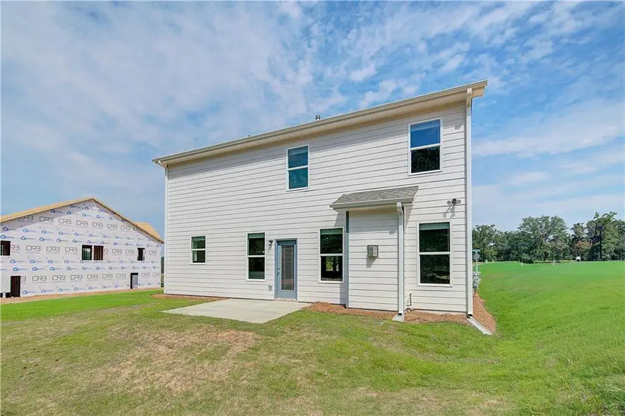 Front exterior of a new home in Abbotts Crossing, Conyers, GA, highlighting curb appeal (Image 2).