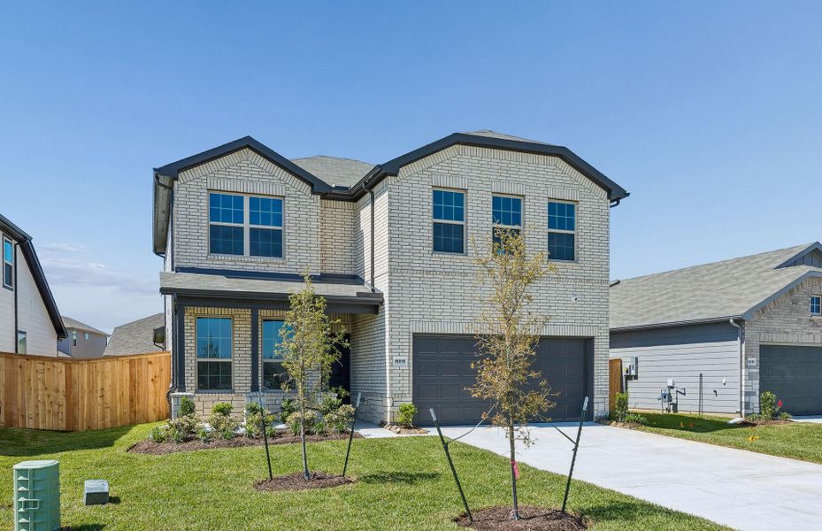 Front exterior of a new home in Mavera, Conroe, TX, highlighting curb appeal (Image 21). Front exterior of a new home in Mavera, Conroe, TX, highlighting curb appeal (Image 21).