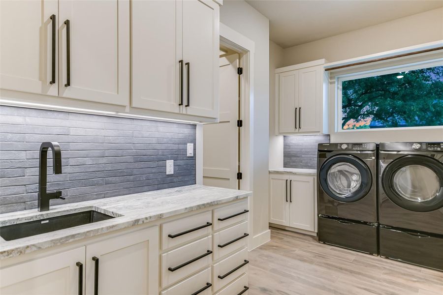 Washroom featuring cabinet space and washing machine and dryer Washroom featuring cabinet space and washing machine and dryer