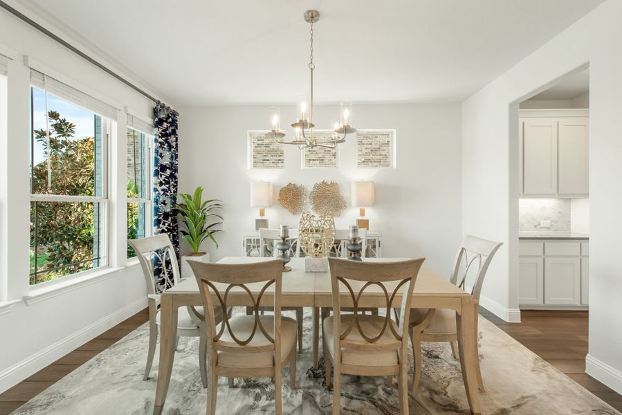 Dining room with six-chair table, chandelier, hardwood floors, and large windows