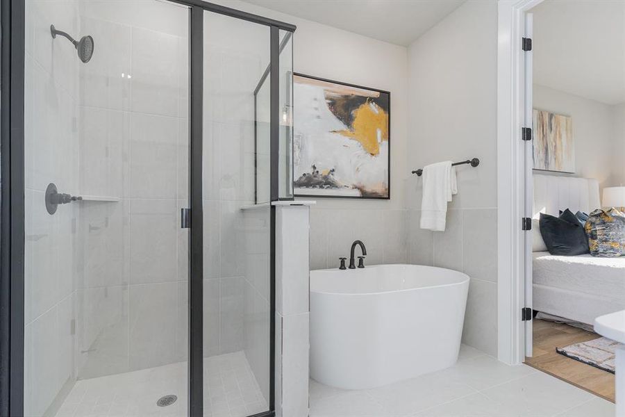 Bathroom featuring hardwood / wood-style floors, tile walls, and independent shower and bath