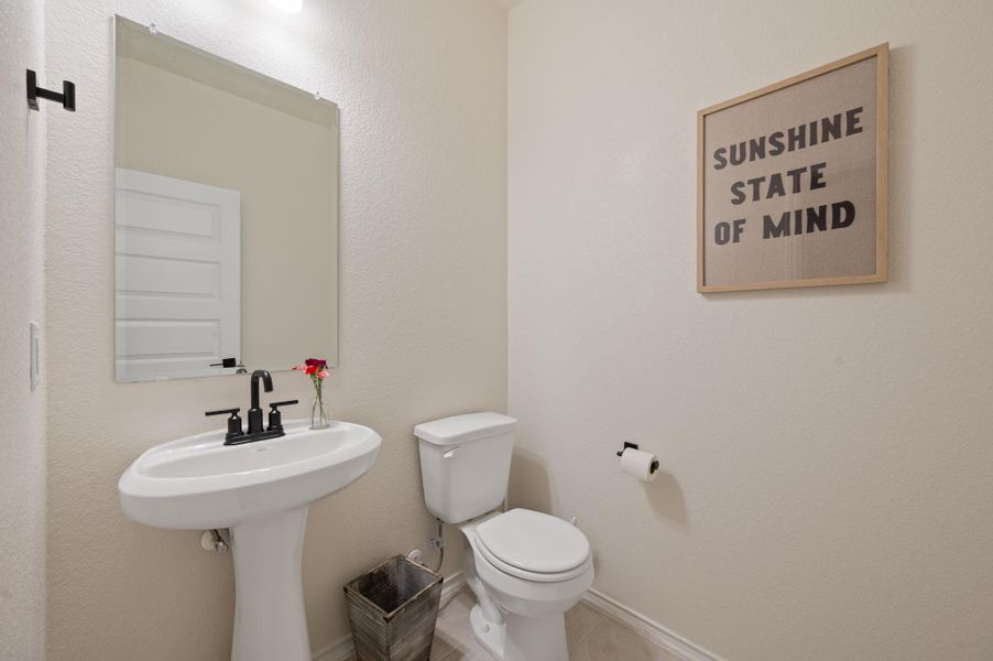Bathroom featuring toilet and a textured wall