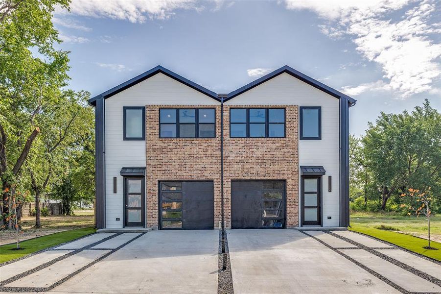 View of front of home featuring brick siding and driveway View of front of home featuring brick siding and driveway