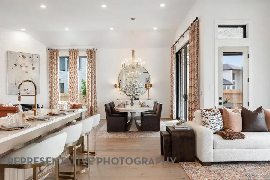 Living room featuring a healthy amount of sunlight, recessed lighting, light wood-type flooring, and a chandelier