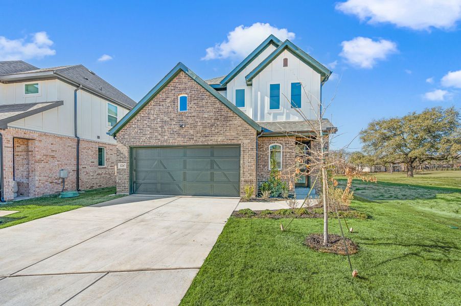 Front exterior of a new home in The Resort on Eagle Mt. Lake, Fort Worth, TX, highlighting curb appeal (Image 27). Front exterior of a new home in The Resort on Eagle Mt. Lake, Fort Worth, TX, highlighting curb appeal (Image 27).