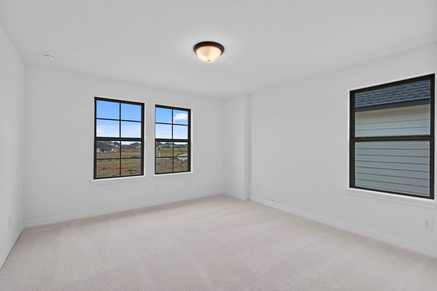 A generously sized secondary bedroom with ample natural light.