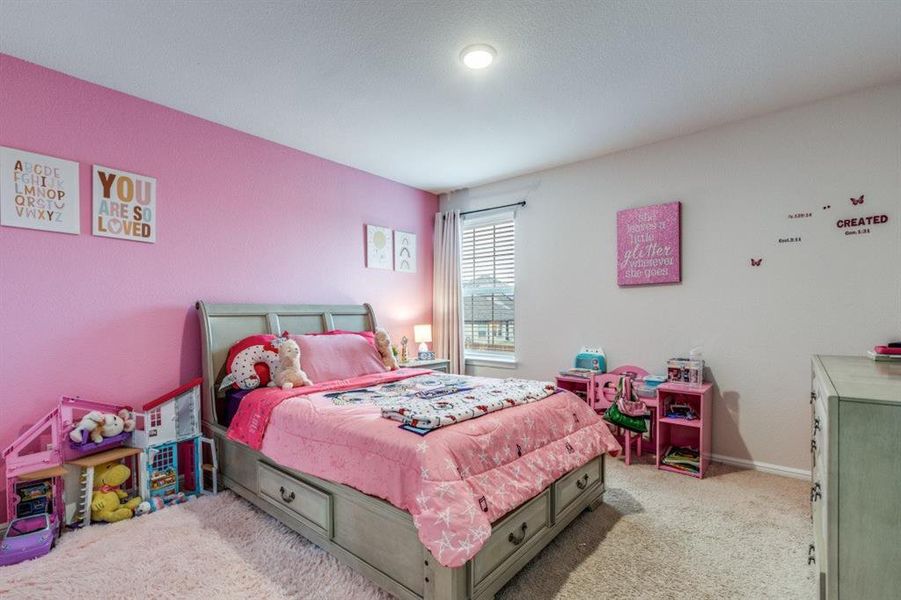 Bedroom featuring light colored carpet and baseboards