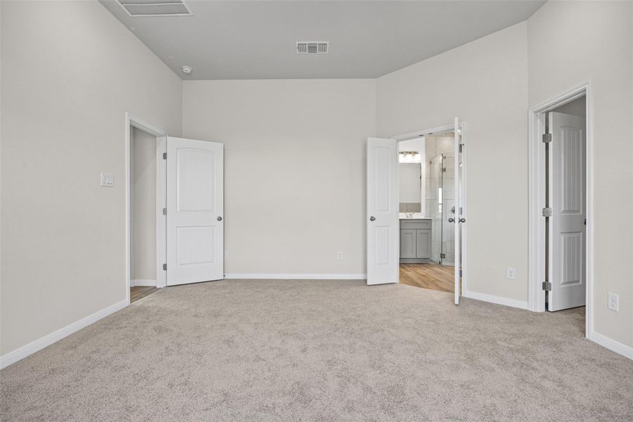 Primary bedroom with plush carpeting, recess lighting, fan and direct access to an en-suite bathroom. Primary bedroom with plush carpeting, recess lighting, fan and direct access to an en-suite bathroom.