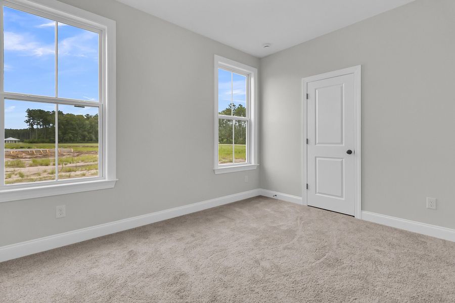 Spacious, unfurnished interior of a new home in Tidewater at Lakes of Cane Bay, Summerville (Image 32).